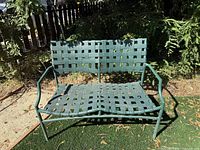 Front view of green Brown Jordan strap bench showing overall design and condition