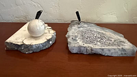 Both stone pen holders side by side on desk