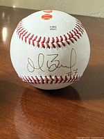 Signature side of Rawlings Official League baseball showing hand-signed marker signature with #7
