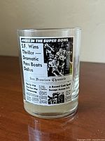 Front of glass showing newspaper headline graphic