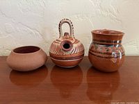 Front view of three Tonala pottery vessels