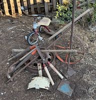 Pile of assorted vintage garden tools and parts on ground