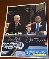 Signed photograph showing Bill King and Vida Blue on Comcast SportsNet set with signatures visible
