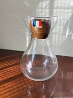 full view of glass beaker showing wood insert and French flag label
