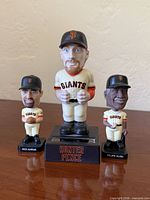Front view of three San Francisco Giants bobblehead figurines – Hunter Pence center, Rich Aurilia left, Felipe Alou right