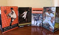 Front view of four San Francisco Giants bobblehead boxes showing player names and images