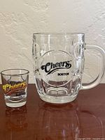 Beer mug and shot glass front logos visible