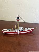 Side view of the carved wooden "Horns Rev" model boat showing hull, mast, rigging and deck details