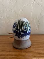 Front view showing floral design and bamboo sticks