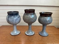 Front view of all three stoneware goblets standing side by side