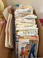 Top view of box showing multiple pattern envelopes, Simplicity 9502 visible
