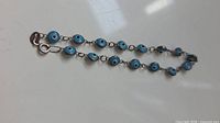 Full view of bracelet showing all evil eye charms and clasp