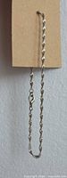 Bracelet hanging to show full twisted chain and clasp