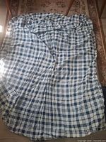 White & blue plaid fitted sheet spread out