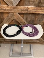 Black and purple XLR cables laid out side by side