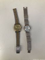 Front view of both wristwatches showing dials and bracelets