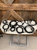 Overview of all six black XLR cables on table