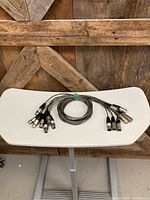 All seven coiled XLR cables on table
