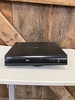 Front view of Akai AKDVD901 DVD player showing tray and control buttons