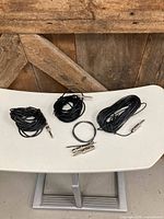 Group shot of the four coiled audio cables showing connectors and cable condition
