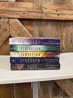 Stack of all five books showing spines with titles and numbering