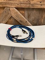 Entire cable coiled on table showing blue-black exterior and connectors