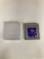 Front of Tetris cartridge next to clear case