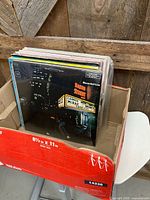 Front view of box showing top album Count Basie "Basie Street" and additional records behind