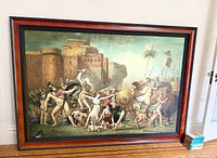 Full view of framed painting leaning against wall