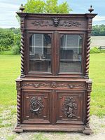 Front view of entire oak hunt sideboard showing carved details and two-piece structure