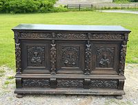 Front view showing carved panels, overall condition