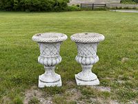 Front view of both matching composite rosette urn planters