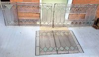 All three stained glass window panels laid out showing overall sizes and designs