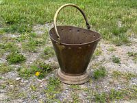 Overall view of brass coal scuttle outdoors