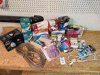 Overview of all boxed bulbs, rope light, loose bulbs and accessories on workbench
