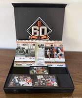 Entire open presentation box with ticket book and cards visible