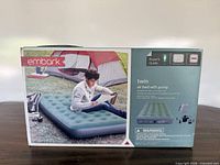 Front of box showing Embark twin air bed with pump and product imagery