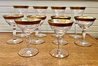 Front view of all ten gold-rimmed glasses