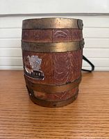 Front view of oak barrel showing brass straps and label