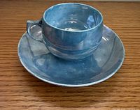 Teacup on saucer, showing colour and form