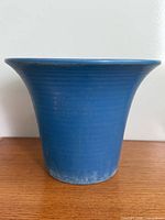 Full side view of blue flared rim planter