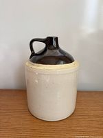 Front view of two-tone stoneware jug on wood surface