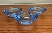 Three blue glass votive holders front angled view
