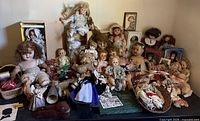 Full collection laid out on table showing variety of dolls, clothing and accessories