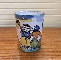 Front view showing painted figures on mug