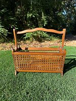 Front view showing walnut frame, woven cane panel and handle