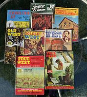 All eight western magazines spread on glass table