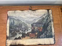 Front view of Currier & Ives "The Route to California" lithograph with hanging ring and burnt-look edges