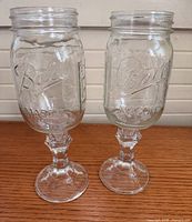 Front view showing Ball Mason embossing and stems