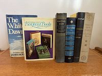 Group shot of all six books standing on shelf